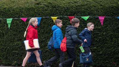 Children arrive to school in the UK, March 8, 2021. PA via AP