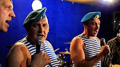 Russian paratroopers Mikhail Vistitsky, centre, and Stanislav Baranov, right, perform during a rehearsal in Moscow. Their song against Vladimir Putin, the prime minister and presidential candidate, became an internet hit and part of a recent wave of protest art in Russia.