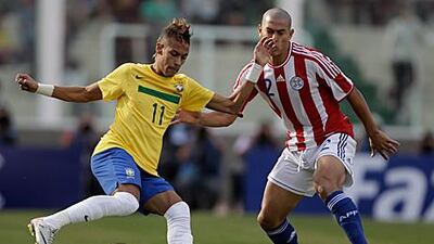 Neymar, the Brazilian attacker, controls the ball from Paraguay's Dario Veron during their 2-2 in the Copa America.
