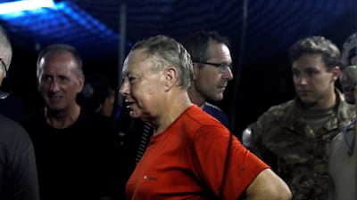 British divers Robert Charles Harper and John Volanthen chat with Thailand military officer, not pictured, near the Tham Luang cave complex, as members of under-16 soccer team and their coach have been found alive according to a local media's report, in the northern province of Chiang Rai, Thailand, on July 2, 2018. Soe Zeya Tun / Reuters