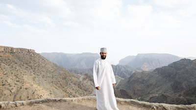 Tour guide Marwan Al Suqri on one of the rose terrace gardens in Al Ayn village.