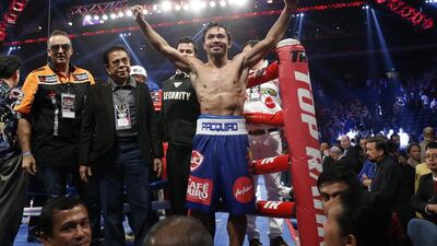 Manny Pacquiao, celebrating after his win over Chris Algieri on November 23, is not paying any special attention to Floyd Mayweather. Kin Cheung / AP Photo