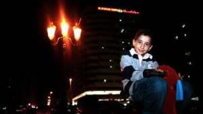 Eight-year-old Mustafa Atef playing in a park near his family's home in Sharjah.