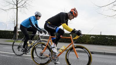 In this picture taken on March 16, 2015 US Secretary of State John Kerry (R) rides his bike during a break in Lausanne. According to an official spokesperson, Kerry was taken to hospital after having sustained SUSPECTED leg injuries during a cycling accident near Scionzier, France on May 31, 2015. He was transported via medical helicopter to Hospital University Geneva, where he is currently being evaluated. AFP PHOTO / FABRICE COFFRINI
