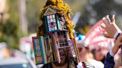 Revellers march in La Societe de Saint Anne Parade. AP
