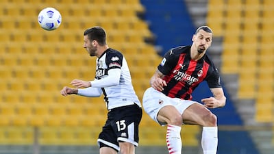 Parma's Mattia Bani with AC Milan's Zlatan Ibrahimovic. Reuters