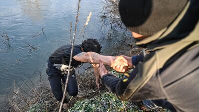 Migrants help each other after an attempt to enter Greece from a location near Edirne, Turkey, by crossing the Maritsa river. AFP