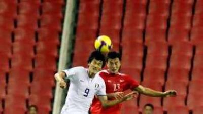 South Korea's Cho Jae-Jin (9) and North Korea's Pak Chol Jin battle for the ball during their World Cup 2010 qualifying match in neutral Shanghai.
