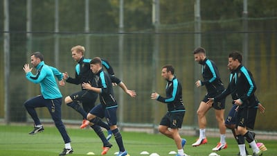 Arsenal players warm up during a their Tuesday training session for Wednesday’s match against Bayern Munich in the Champions League. Dan Mullan / Getty Images