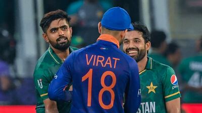 India's then captain Virat Kohli congratulates his Pakistan counterpart Babar Azam, left, and Mohammad Rizwan after their T20 World Cup clash in Dubai on October 24, 2021. AFP