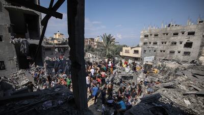 Palestinian residents search the rubble of a destroyed building following an Israeli air strike in Gaza. Bloomberg