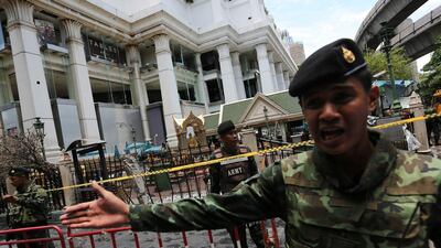 Thai army officers direct people away from the Erawan Shrine in Bangkok. Bloomberg