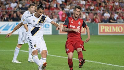 Zlatan Ibrahimovic battles for a ball with Toronto FC midfielder Jay Chapman during the second half at BMO Field. Nick Turchiaro / USA TODAY Sports