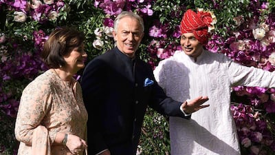 Former British Prime Minister Tony Blair (C) and his wife Cherie Blair (L) are welcomed by Indian businessman Anil Ambani (R), brother of Mukesh Ambani. Photo: AFP