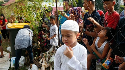 A Muslim boy reacts as Filipinos slaughter goats and cows at the Blue Mosque in Taguig City, east of Manila, Philippines. AP Photo