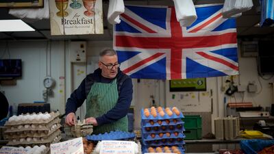 A market trader arranges eggs on his stall in Bolton Market. The UK Chancellor of the Exchequer Jeremy Hunt announced a plan to cut billions in government spending, raise billions more in taxes, while also promising to increase benefits for the poorest. Getty Images