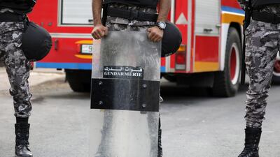 Jordanian security forces stand guard near the French embassy street as a small group of Jordanians protest against the French caricatures on Muslim's Prophet Muhammad in Amman, Jordan. EPA