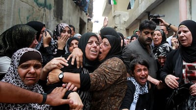 Relatives of 13-year-old Palestinian Abdel Rahman Abdullah, who was shot dead by the Israeli army during clashes at a refugee camp near Bethlehem, mourn during his funeral at the Aida refugee camp near the West Bank town of Bethlehem on October 6, 2015. Musa Al Shaer/AFP Photo