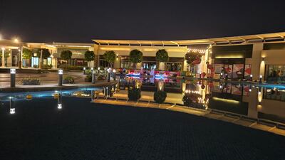 Buildings reflected in the water at the City Walk shopping area in Dubai