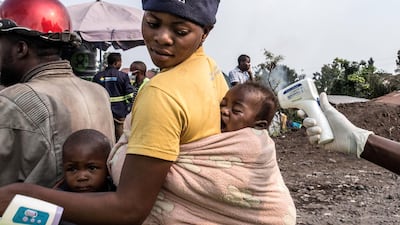 Health authorities checks a baby's temperature at a health checkpoint in Goma, RD Congo. EPA