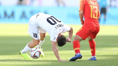 China's Chi Zhongguo, right, watches on as Sagynbaev Bekzhan falls over. EPA