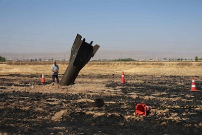 A Syrian farmer stands next to an Iranian missile that fell on agricultural land near Damascus. AFP