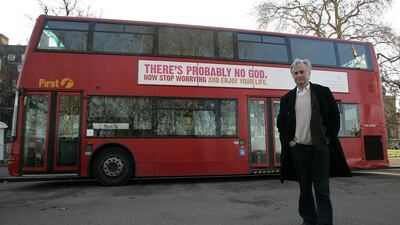 Richard Dawkins, the author of the 'The God Delusion', poses for photographers in front of a London bus featuring an atheist advertisement in London in 2009 (AP Photo/Akira Suemori)