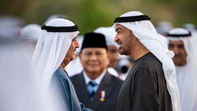 Sheikh Mohamed greets Sheikh Humaid bin Ahmed Al Mualla, as Mr Subianto watches