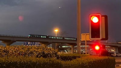 A metro train runs near Ibn Battuta Mall shortly before the curfew. Pawan Singh / The National