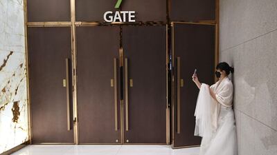 A bride wearing a protective face mask attends a mass wedding ceremony organised by the Unification Church at Cheongshim Peace World Center in Gapyeong. AFP