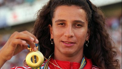 Ghada Shouaa of Syria displays her Olympic gold medal. Thomas Kienzle / AP