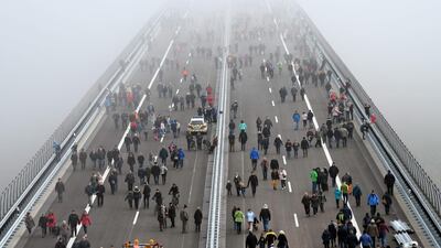 People walk on the Hochmosel Bridge ahead the opening of the bridge after eight years of construction in Zeltingen-Rachtig. AFP