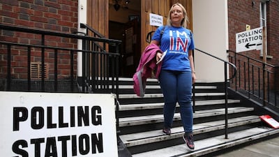 A woman wearing an “I’m In” T-shirt, promoting the official “Remain” campaign, leaves a polling station in London. Justin Tallis / AFP Photo