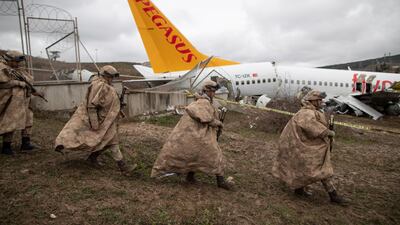 Turkish soldiers secure the wreckage after a Pegasus Airlines aircraft skidded off the Sabiha Goekcen airport runway in Istanbul, Turkey. EPA