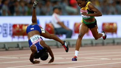 Danielle Williams of Jamaica crosses the finish line to win gold in the Women’s 100 metres hurdles final as Tiffany Porter of Great Britain, left, falls during day seven of the 15th IAAF World Athletics Championships Beijing 2015 at Beijing National Stadium on August 28, 2015 in Beijing, China. Michael Steele / Getty Images
