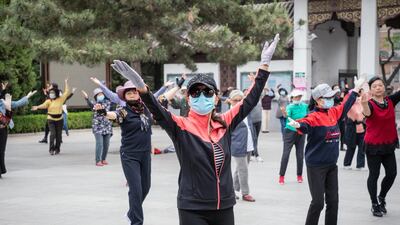People dance at a park in the Chinese capital Beijing on April 21, 2021. Chinese President Xi Jinping on Tuesday called for greater global economic integration. Bloomberg