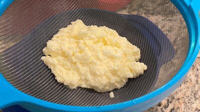 Separate the butter and buttermilk with a sieve. Not pictured: I then moved bowls and poured iced water over the butter and pressed the butter down, to ensure all liquid was out. Farah Andrews / The National