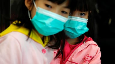 Children wear masks to prevent an outbreak of a new coronavirus at the Hong Kong West Kowloon High Speed Train Station, in Hong Kong, China. Reuters