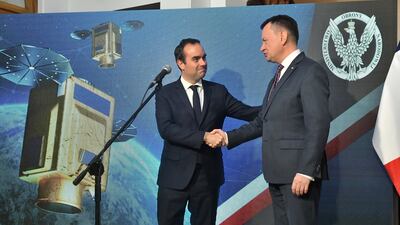 Poland and France's defence ministers signed the satellite deal in Warsaw. EPA