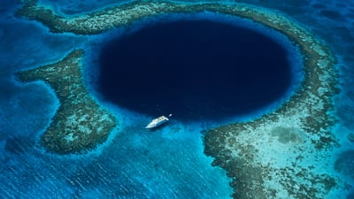 Great Blue Hole lies about 40 miles off the coast of Belize. Getty