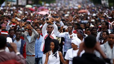 Demonstrators show the Oromo protest gesture sign during Irreecha, the thanksgiving festival of the Oromo people in Bishoftu town of Oromia region, Ethiopia on October 2, 2016. Police fired tear gas at protestors, sparking a stampeded that reportedly killed dozens. Tiksa Negeri/Reuters