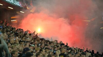 Ajax supporters set off a flare inside the Friends Arena during the Europa League final. Peter Powell / EPA