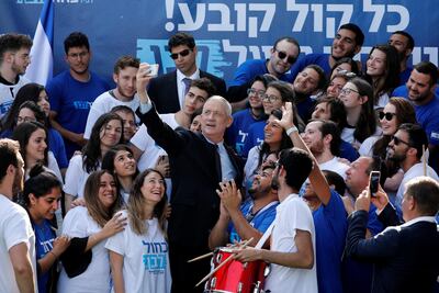 Benny Gantz, leader of Blue and White party, takes a selfie together with supporters outside the party headquarters in Tel Aviv. Reuters