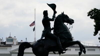 The American flag flies at half-mast over the White House. AP
