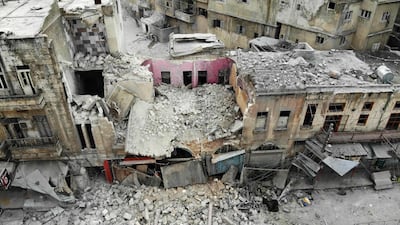An aerial view shows a destroyed building following a regime air strike on Ariha. AFP