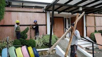 Workers cover the windows of a hotel with sheets of plywood as Typhoon Mangkhut nears Cagayan province, northeastern Philippines. Aaron Favila / AP Photo