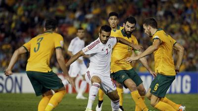 UAE's Ali Mabkhout fights for the ball with Australia's Jason Davidson, left, Mile Jedinak, second right and Matthew Spiranovic during Tuesday's Asian Cup semi-final. Edgar Su / Reuters