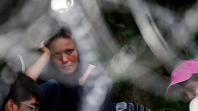 An Afghan woman and her family on the Hungarian-Serbian border. Attila Kisbendek / AFP Photo