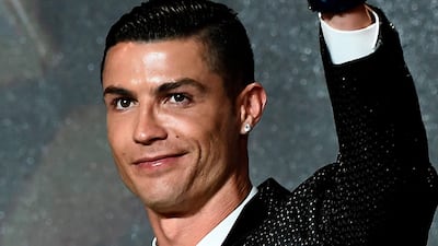 Juventus' Portuguese forward Cristiano Ronaldo celebrates receiving the 433 Fans' Award during the 10th edition of the Dubai Globe Soccer Awards in Dubai. AFP