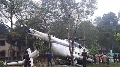 Bangladeshi authorities check the site of a helicopter crash which was carrying Kuwait's chief of staff Lieutenant General Mohammed Khaled Al Khadher. KUNA